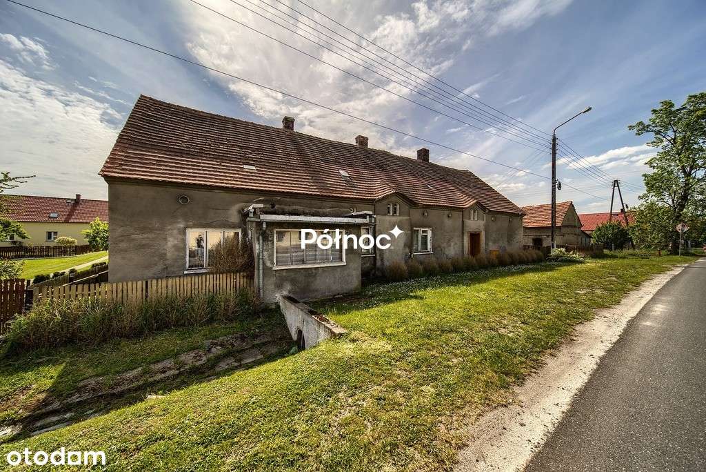 Działka zabudowana domem i budynkami gospodarczymi