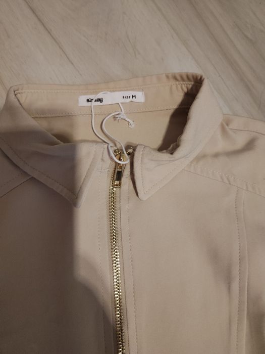 Beżowa sukienka z kołnierzykiem i złotym zamkiem