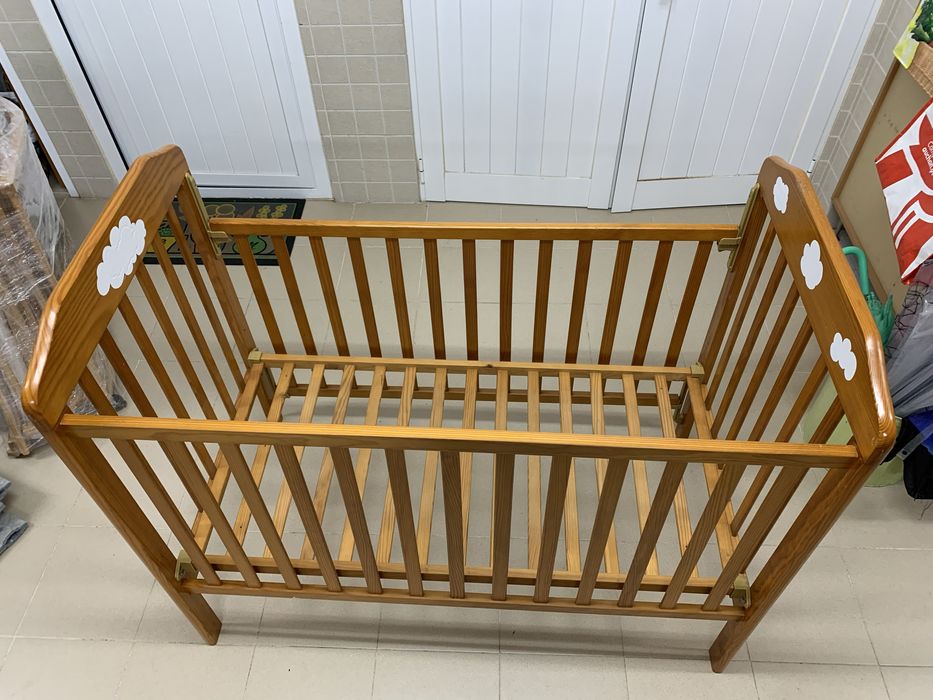 Berço em madeira maciça com grade que sobe e desce.