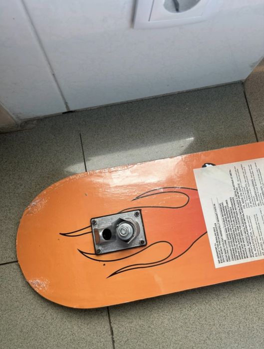 Black skatebroad with orange graphic