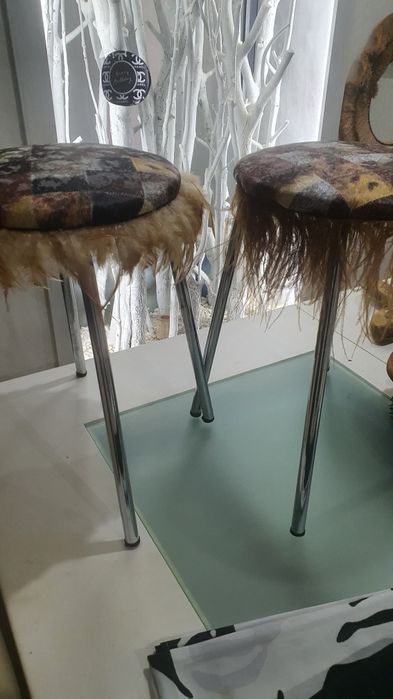 Vários bancos em pele com penas de um criador de decoração