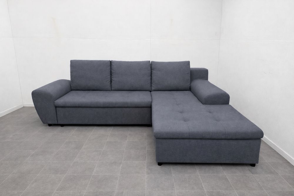 Szary narożnik rozkładany z funkcją spania używany transport