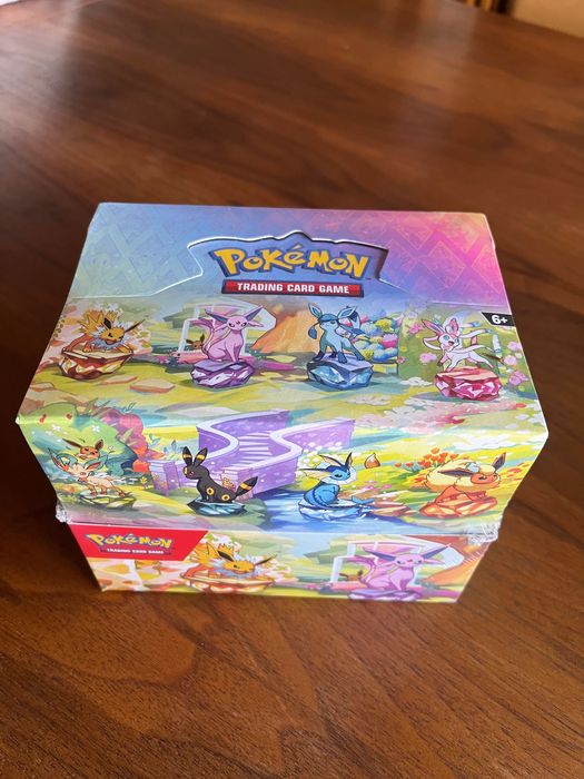 Pokémon “Prismatic Evolutions” Tins Display