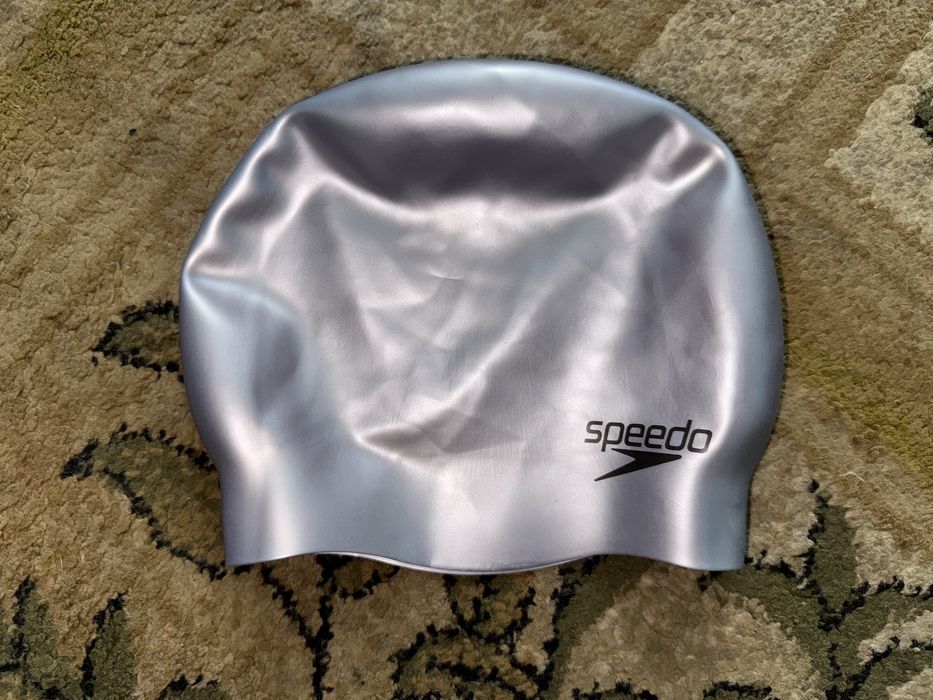 Срібляста силіконова шапочка для плавання бренду Speedo.