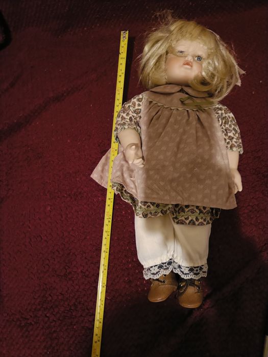 Boneca de porcelana com almofada de ursinho  dela