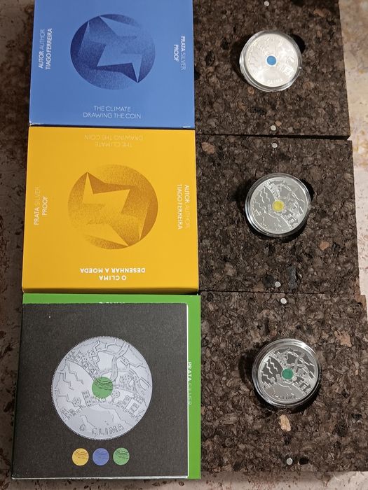 3 moedas prata prof de 5€ . O  Clima