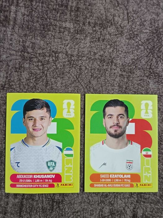 Cromos Mundial 2026 - Abdukodir Khusanov (UZB) / Saeed Ezatolahi (IRN)