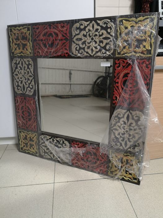 Espelho com moldura de madeira trabalhada