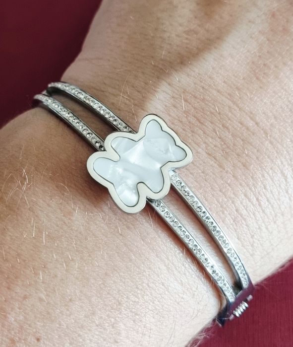 Pulseira/escrava prateada, em aço, com zirconias e um urso em madrepér