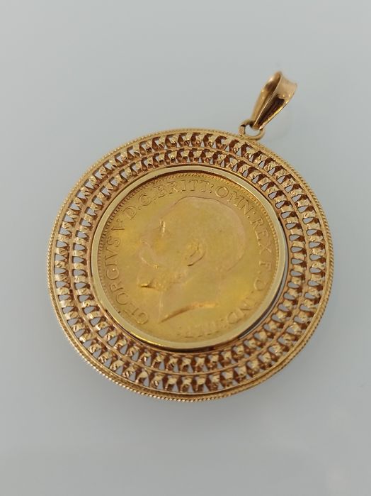 Medalha libra em ouro de 22kt com aro de 19,2kt