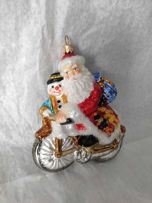 Szklana bombka Huras Family Mikołaj z bałwanem na rowerze