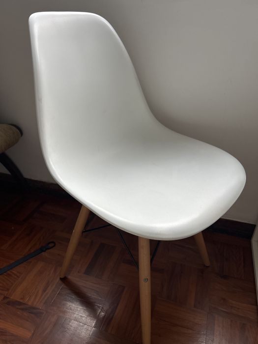 Cadeiras brancas e cinzas com pernas de madeira