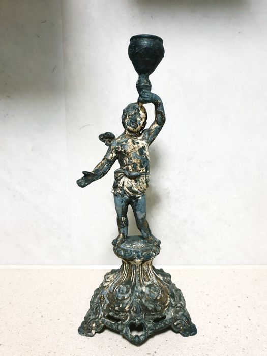 Antique 19th-century candlestick featuring a cast-metal angel