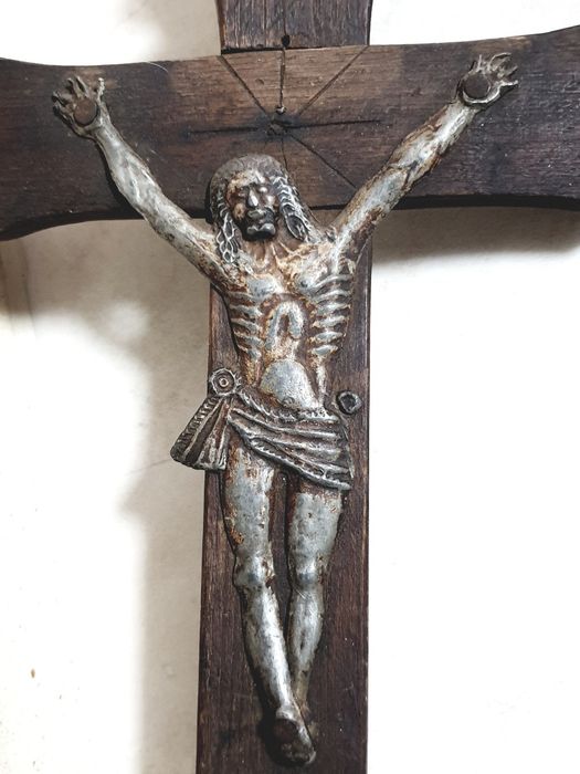 Old popular wall-hanging crucifix made of wood and tin