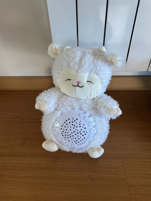 Peluche branco luminoso e com música