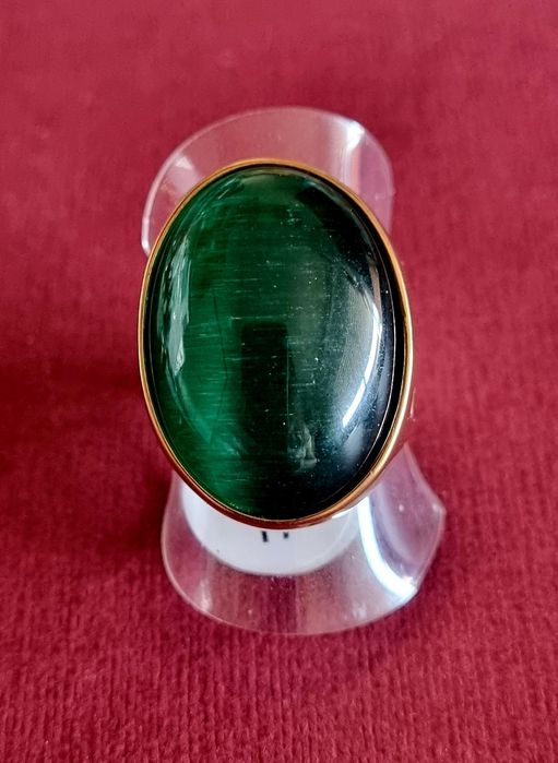 Anel dourado, em aço, com grande pedra verde oval. T17