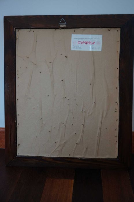 Obraz ze skóry w drewnianej ramie.