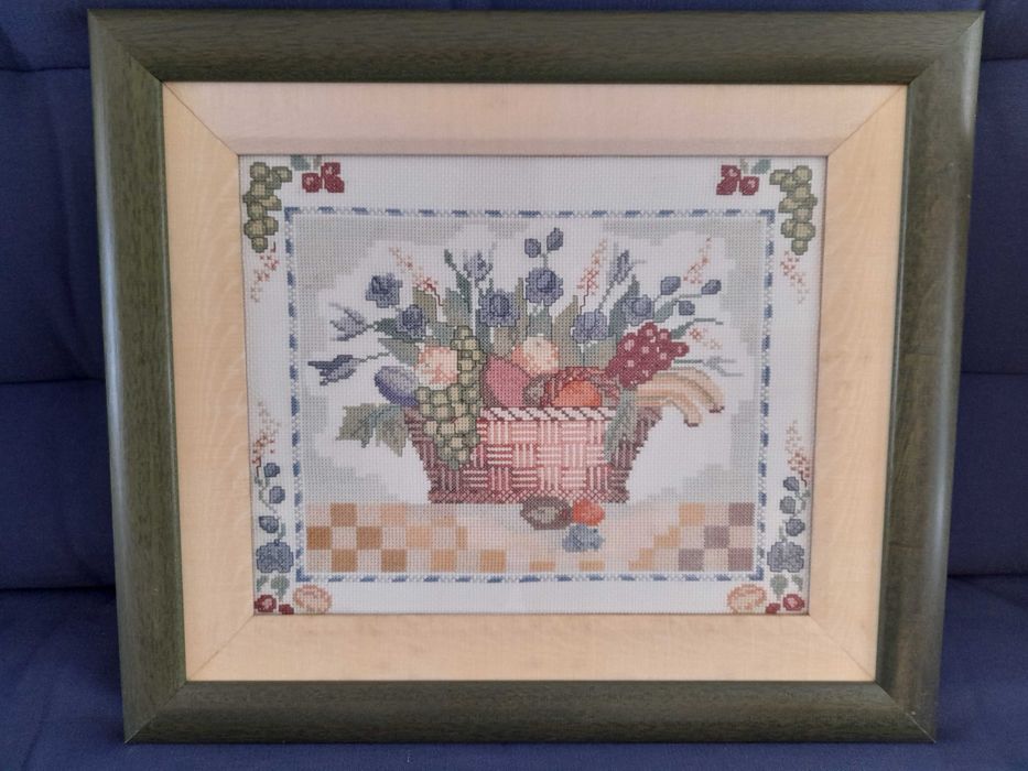 Quadro bordado a ponto cruz e emoldurado.