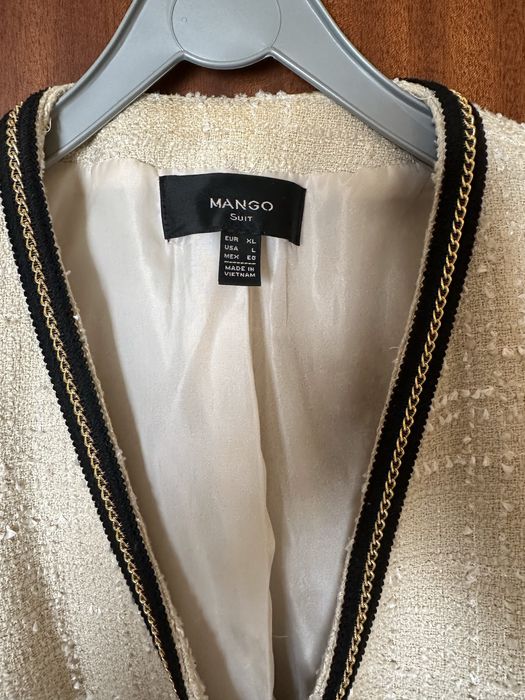 Casaco boucle bege e preto Mango