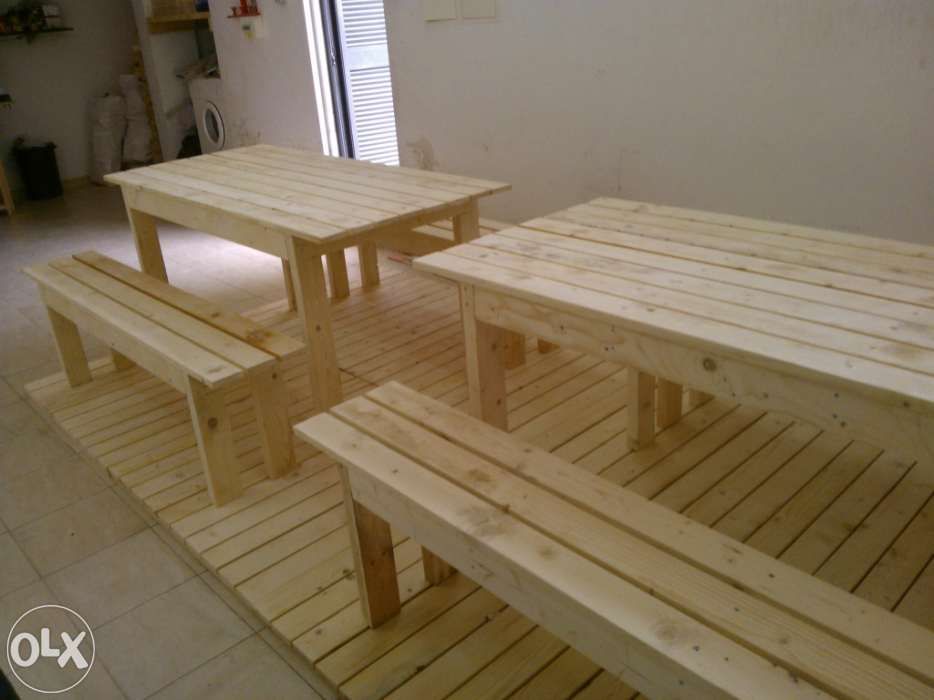 Vários conjuntos de mesas e bancos corridos.