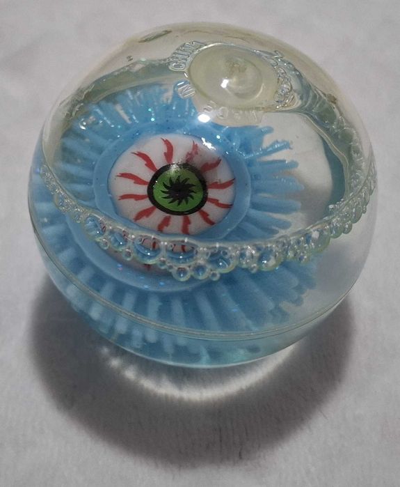 Gumowa kulka z okiem, brokatem, niebieska, 6cm (Zabawka)
