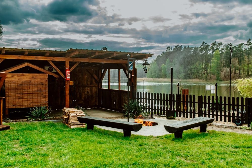 Domek nad jeziorem z jacuzzi, sauną i strefą masażu .