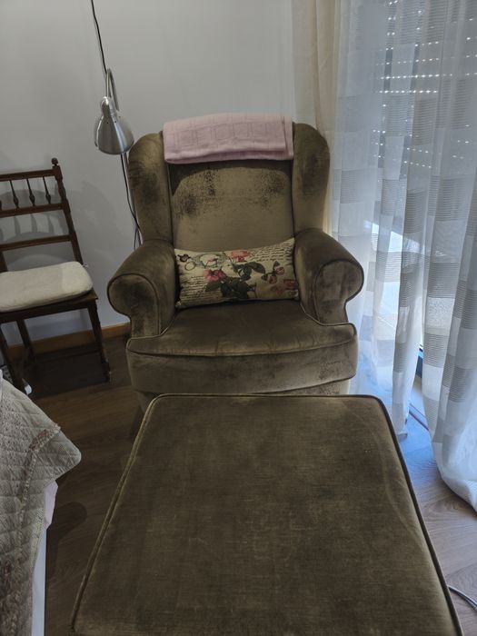 Poltrona de veludo verde e repousa pés