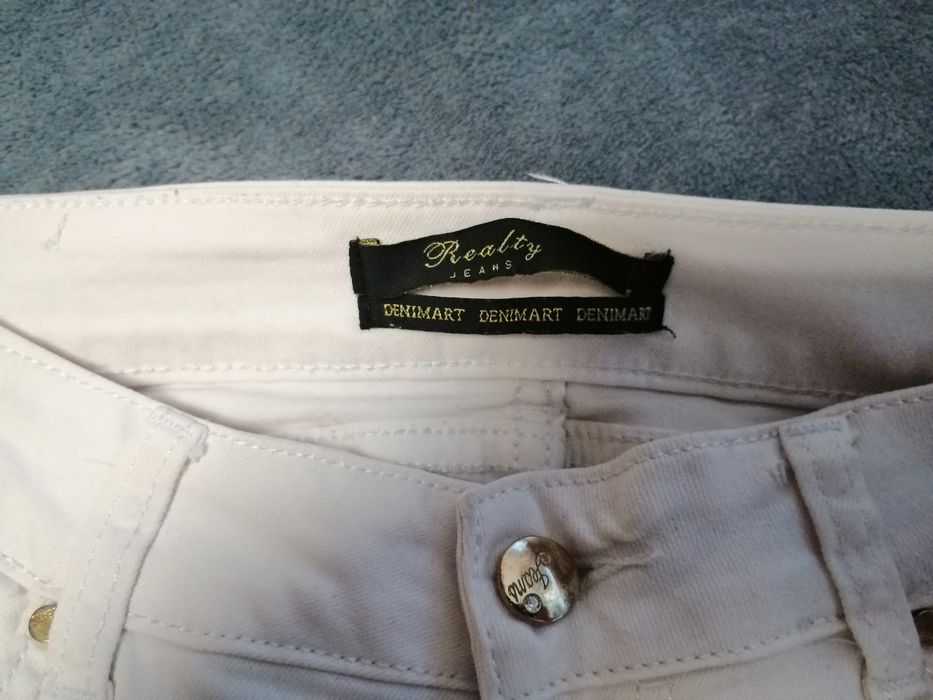 Białe eleganckie jeansy 38