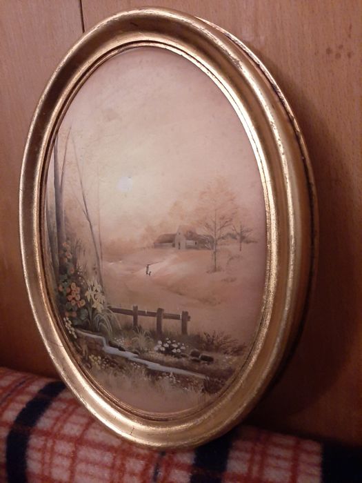 Quadro Vintage Oval em moldura dourada.