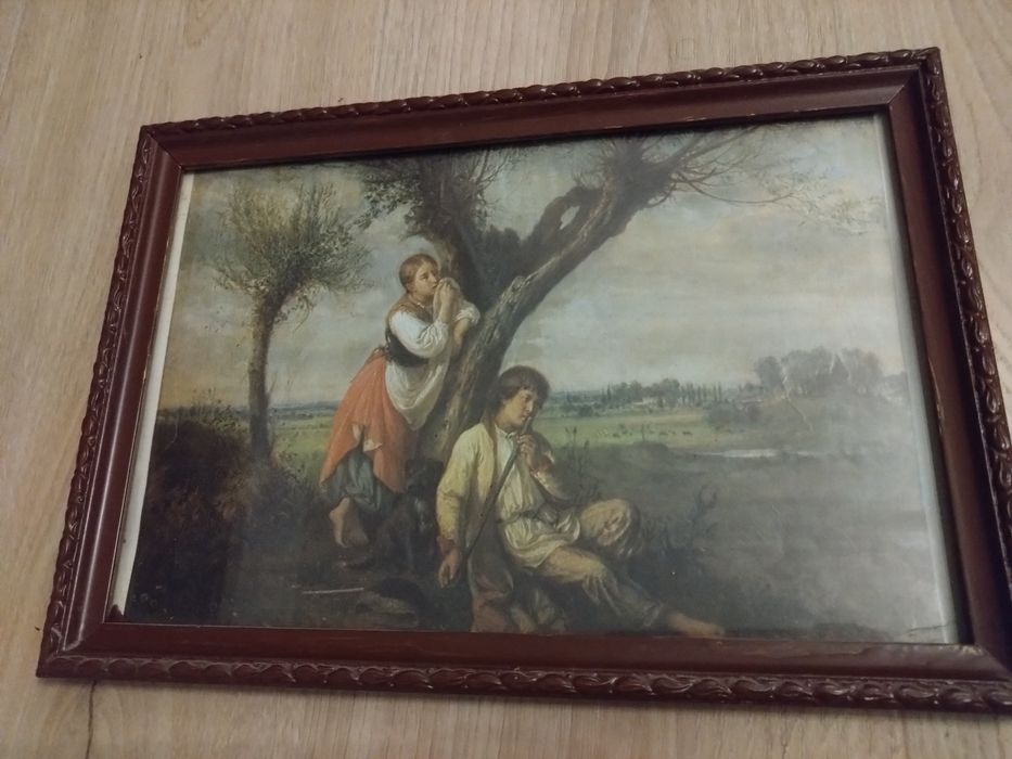 Obrazek w ramce. Dwoje ludzi pod drzewem.