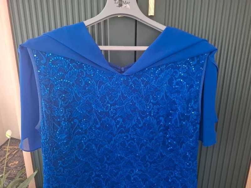 Elegancka chabrowa sukienka koronkowa z cekinami i pelerynką