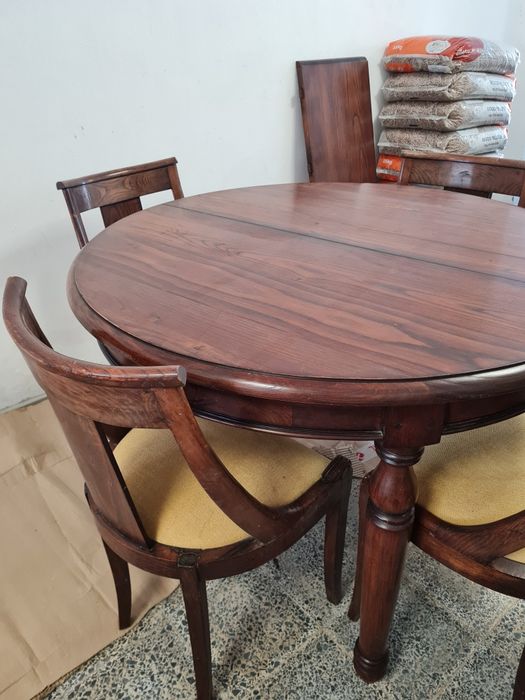 Mesa de jantar extensível e quatro cadeiras.