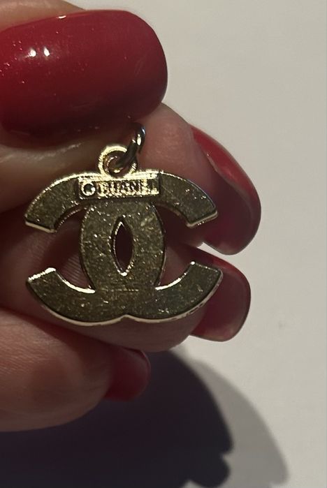 Czarno zlota logowana zawieszka, jak pikowana torebka