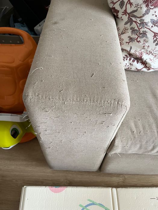 Sofá cama de dois lugares com marcas de uso