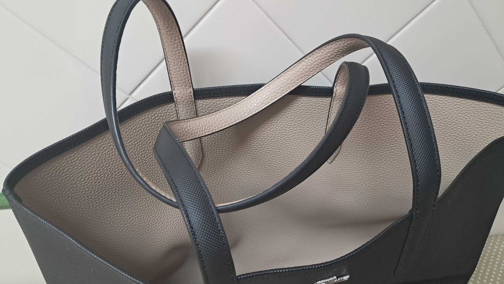 Mala original Lacoste preta, que pode reverter para bege, como nova.