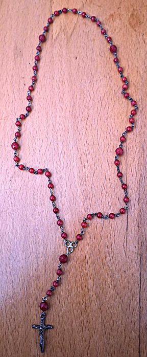 Terço com pedras vermelhas e cruz em prata