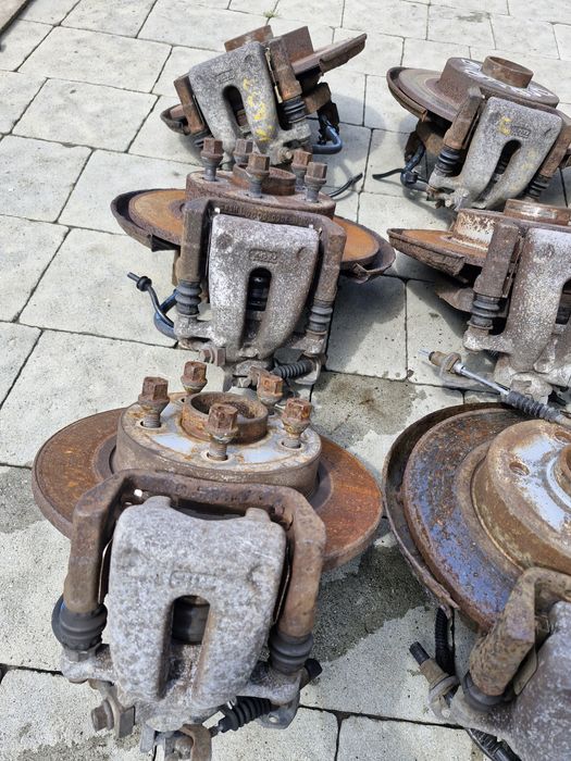 супорт задній диск тормозний Opel Astra H Zafira B