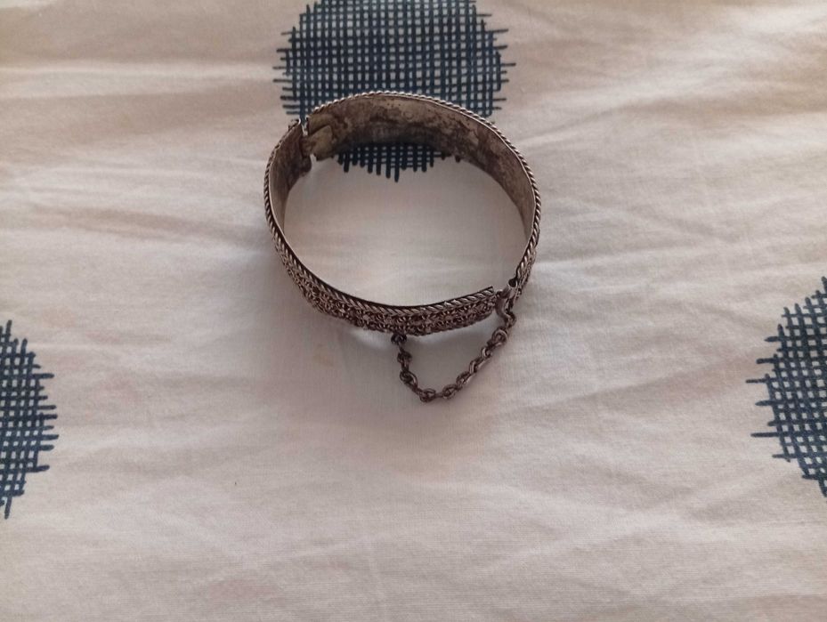 Pulseira em metal marroquino, trabalhada e com fecho e corrente.