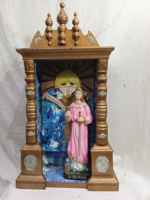 Altar a Santa Barbara. Antiga caixa de relógio pintada na cor ouro