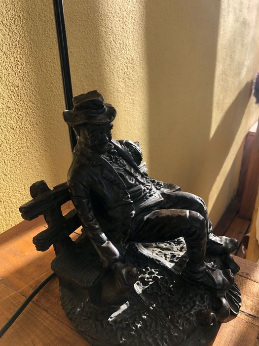 Candeeiro antigo velho sentado num banco de jardim