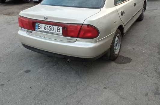 Задній бампер Mazda 323 ba седан