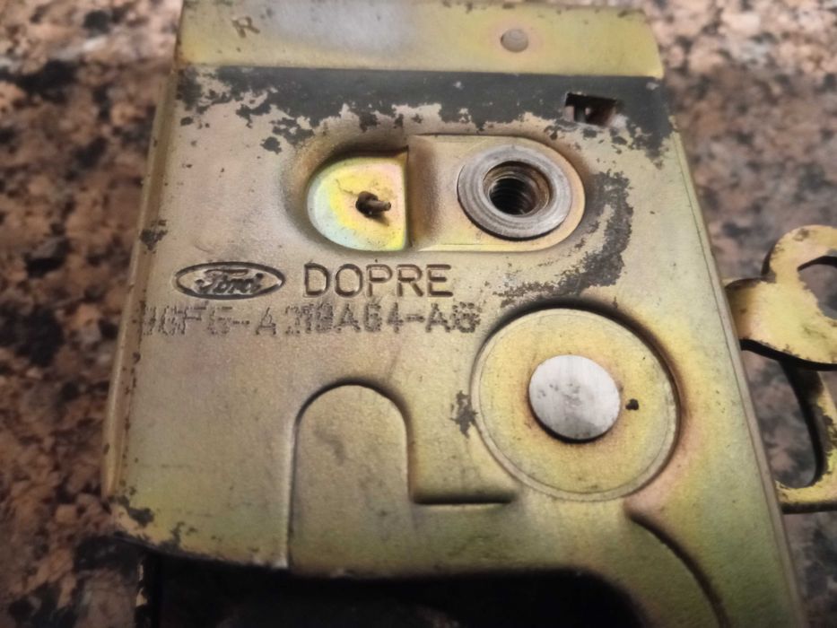 Замок передній правий дверки 96FG-A219A64-AB Фієста Кур’єр Мк4 Dopre