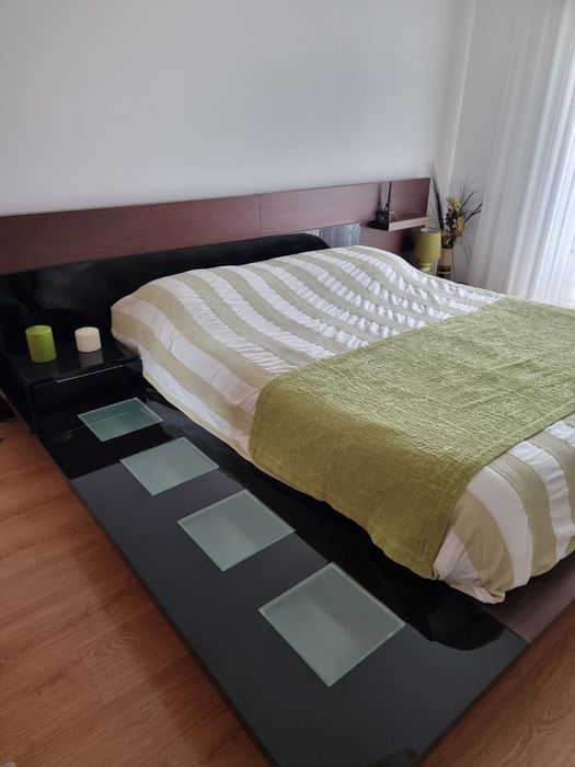 Cama de casal com mesa cabeceira e luz lateral