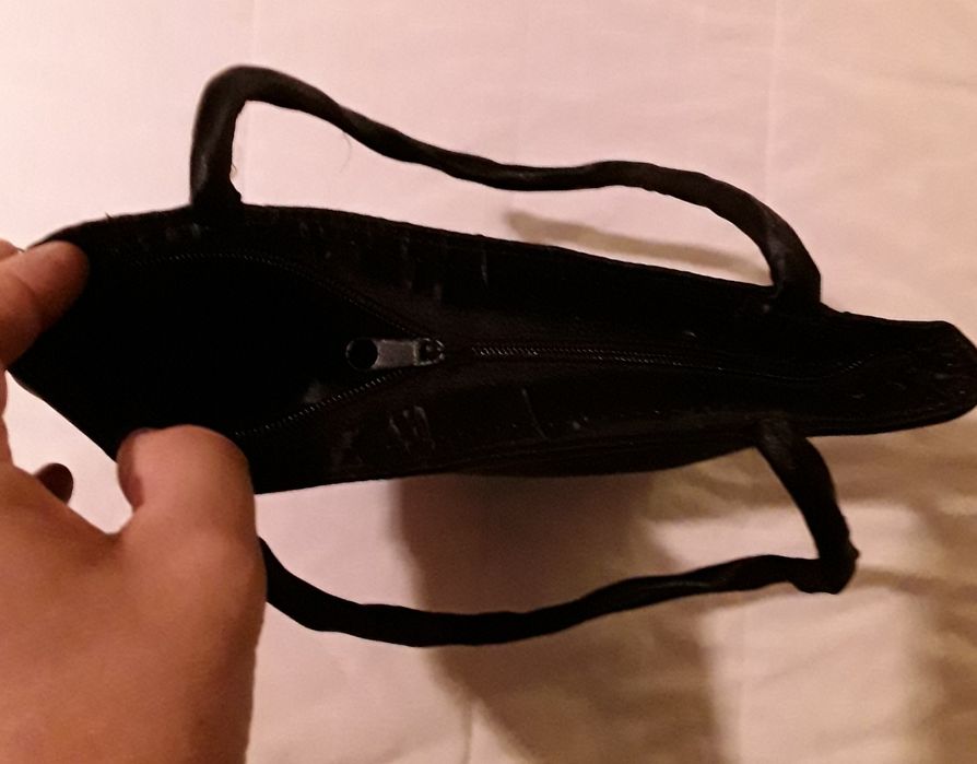 Bolsa ou mala de mão preta com aplicação circular vermelha