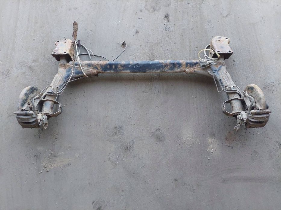 BELKA OŚ ZAWIESZENIA TYŁ + TARCZE ZACISKI VW PASSAT B4 93-97r KOMBI