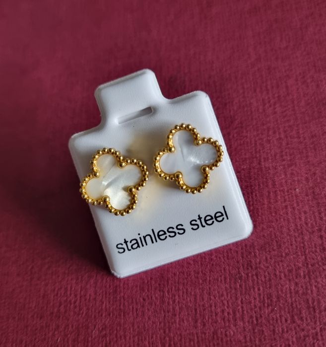 Brincos dourados, em aço, trevos brancos ou pretos. De pico.