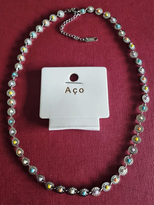 Colar/gargantilha prateado, em aço, com pequenas bolinhas coloridas. T