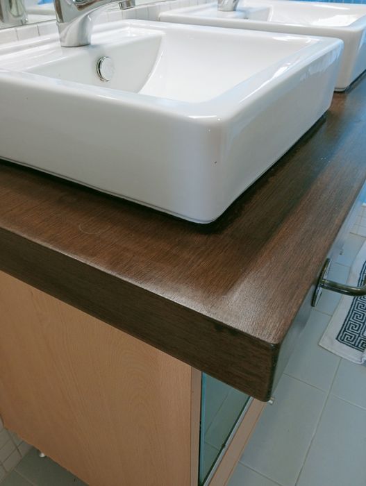 Bancada de Madeira maciça com dois lavatórios e duas torneiras.