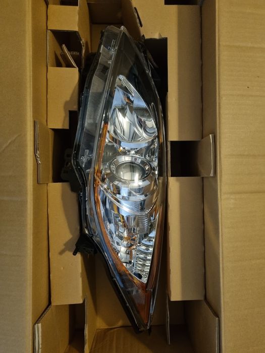 Reflektor lampa Mazda 3, 08- nowy, oryginalny, lewy.