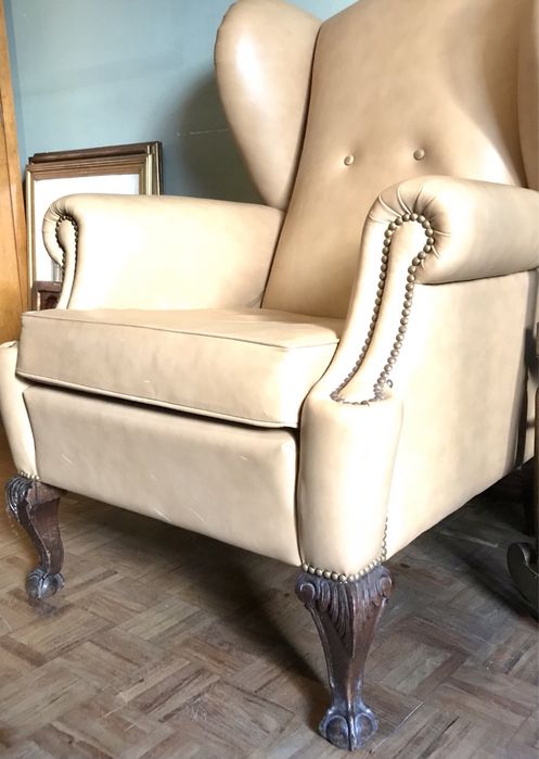 Restored leather armchair with lion-paw feet